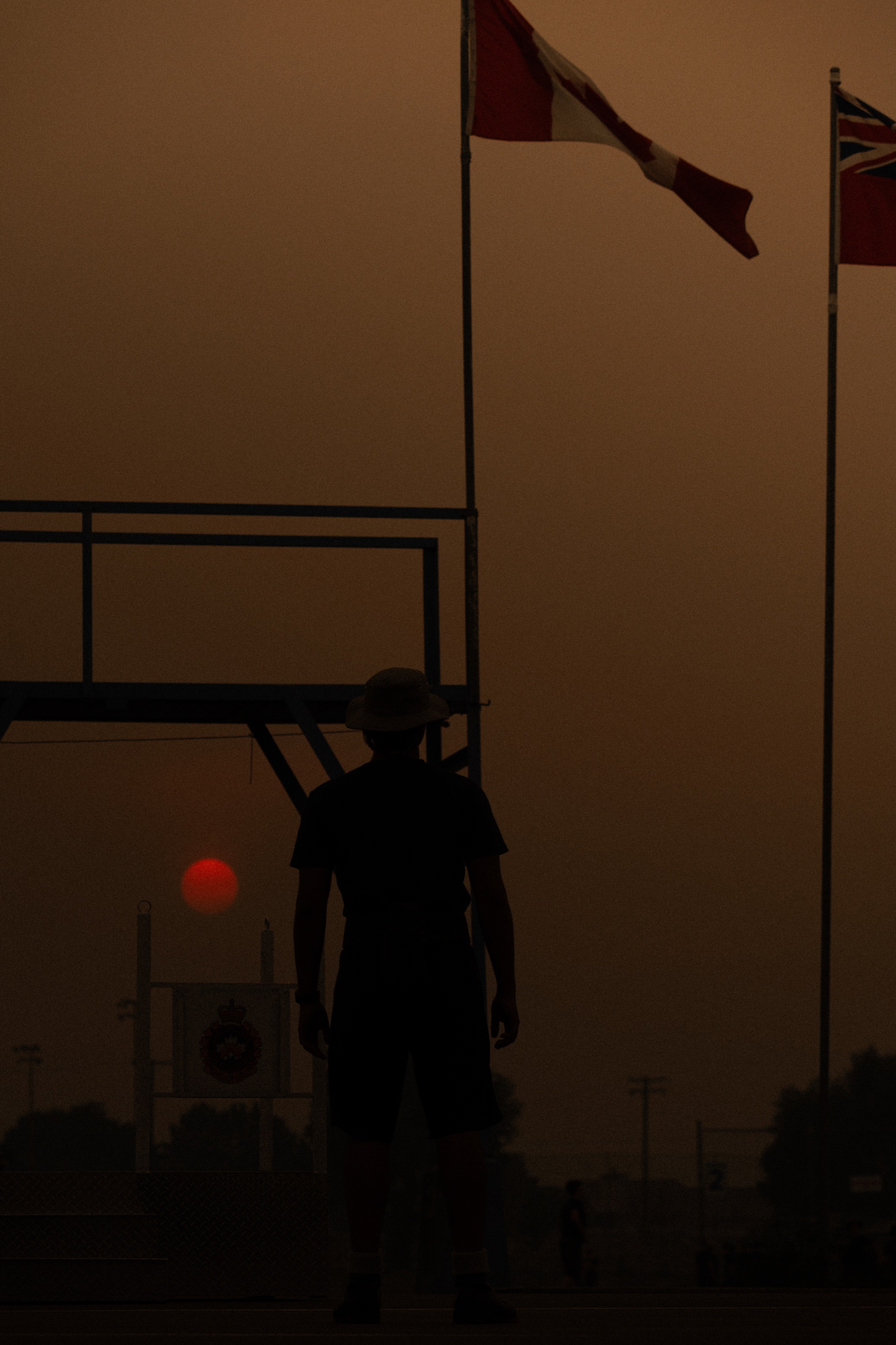 Athlete silhouette on a field at sunset